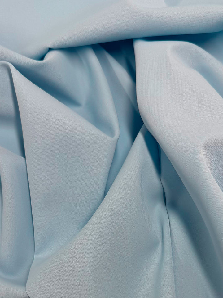 Super Cheap Fabrics' Microfibre Suiting - Nantucket Breeze (150cm) features a lightweight, soft light blue fabric with a smooth texture, gently draping to capture the airy, breezy look with subtle highlights and shadows.