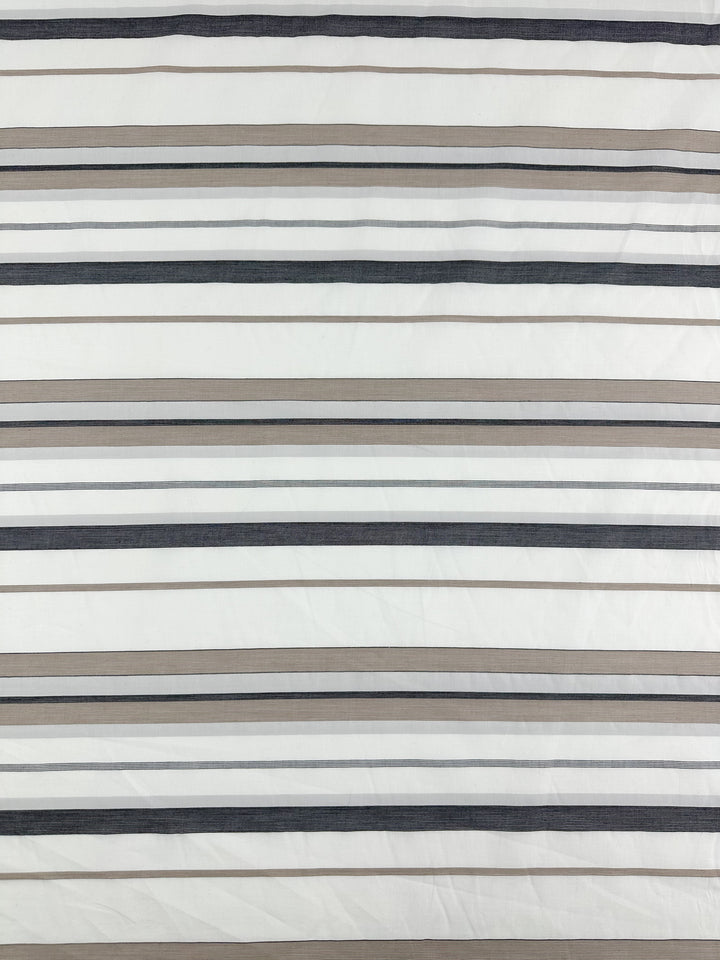 The Cotton Voile - Creamy Nimbus - 155cm by Super Cheap Fabrics is a lightweight fabric featuring horizontal stripes with alternating thin and thick lines in shades of gray, beige, and white, evenly spaced against a creamy white background. The breathable material has a slightly textured appearance with a smooth finish.