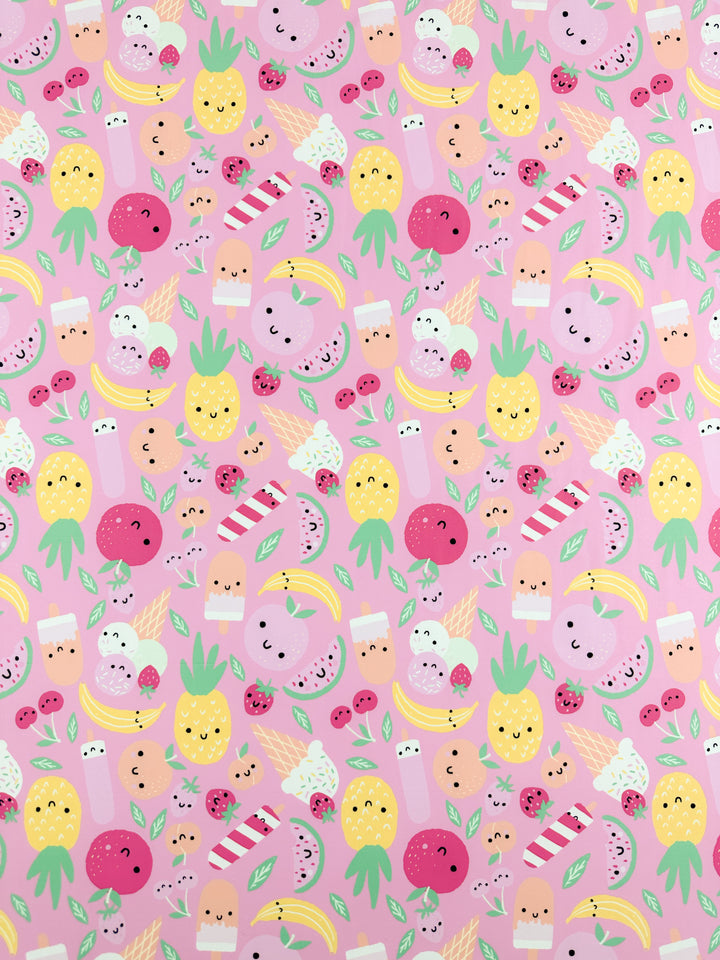 Introducing the "Fruit Salad" Printed Nylon Lycra from Super Cheap Fabrics, featuring a vibrant pattern of various cute, smiling pineapples, watermelons, strawberries, bananas, ice creams, milk cartons, and candies—all set against a pink background. This multiuse design showcases cheerful faces and bright colors on a soft fabric with a high-quality print. Measuring 152cm wide.