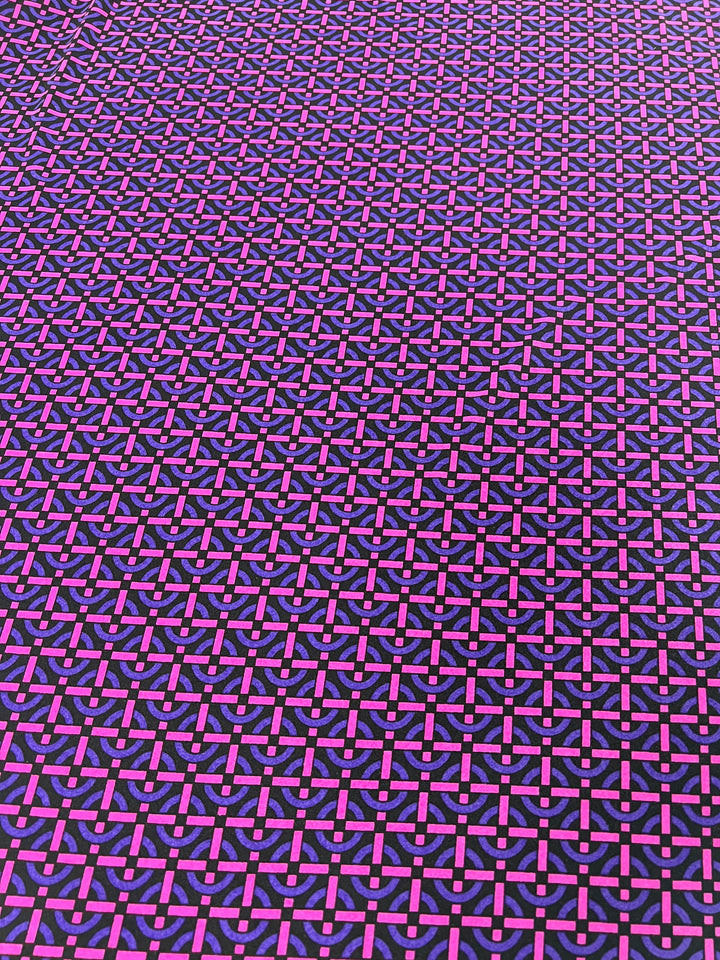 An image showing a seamless, intricate geometric pattern with overlapping shapes in shades of purple and pink, set against a black background. The design, reminiscent of Super Cheap Fabrics' Printed Lycra - Loopholes - 150cm, is repetitive and creates an optical illusion, adding depth and complexity to the visual.