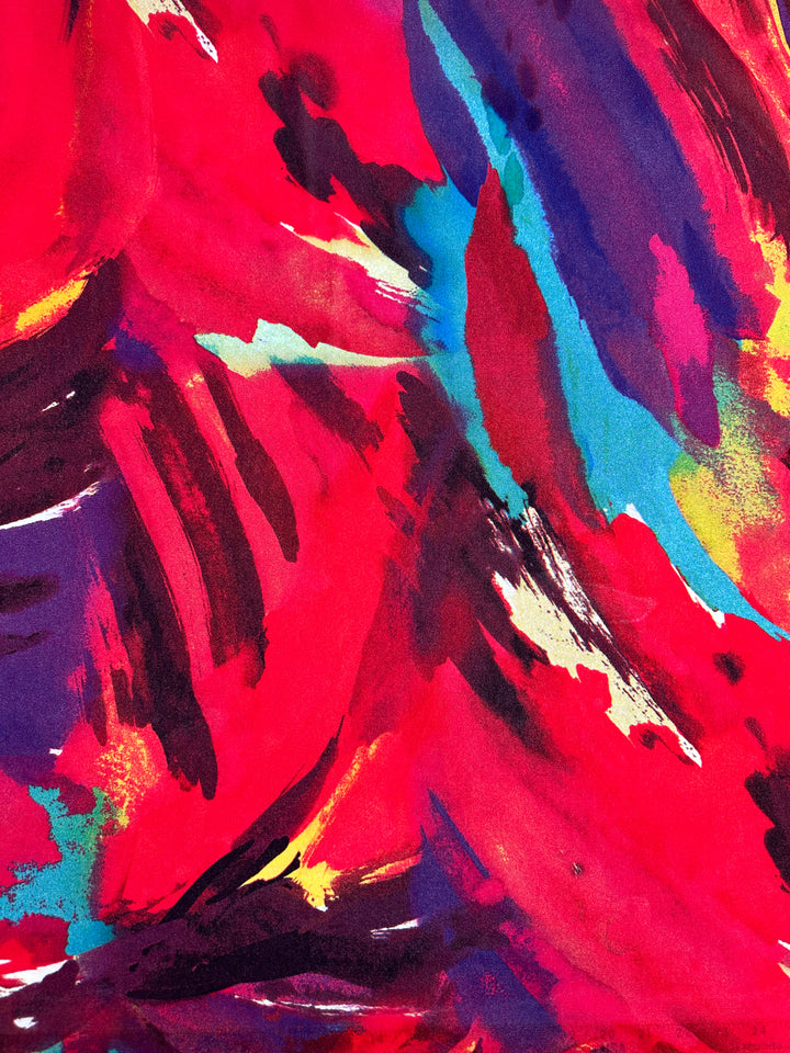 An abstract painting featuring dynamic, bold brushstrokes in vibrant red, with accents of blue, purple, yellow, and green. The colors and strokes intersect and blend like the Printed Mesh - Infawave fabric from Super Cheap Fabrics, creating a sense of movement and energy.