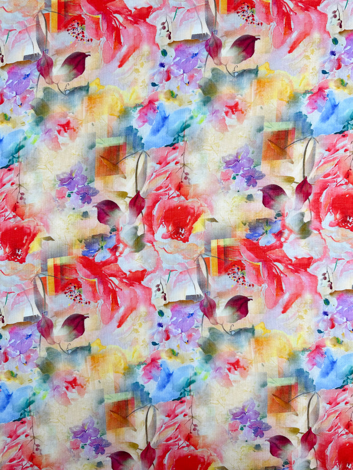 Discover the Designer Cotton - Reflection - 150cm by Super Cheap Fabrics, featuring a vibrant abstract floral design. Splashes of red, pink, purple, and yellow blend seamlessly with green leaves and geometric prints on a textured beige background. Ideal for luxury sewing projects.