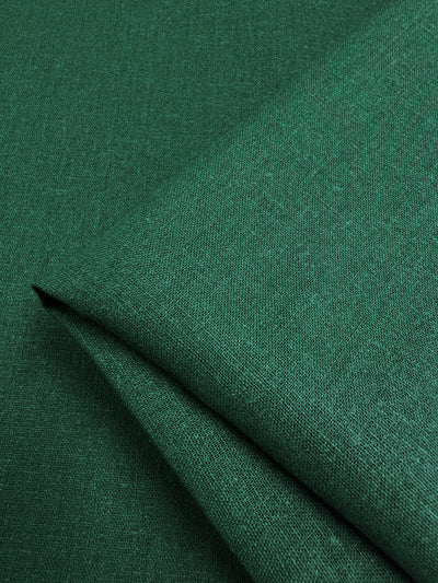 Close-up of folded aventurine Premium Linen Cotton fabric, featuring a subtle textured pattern, from Super Cheap Fabrics.