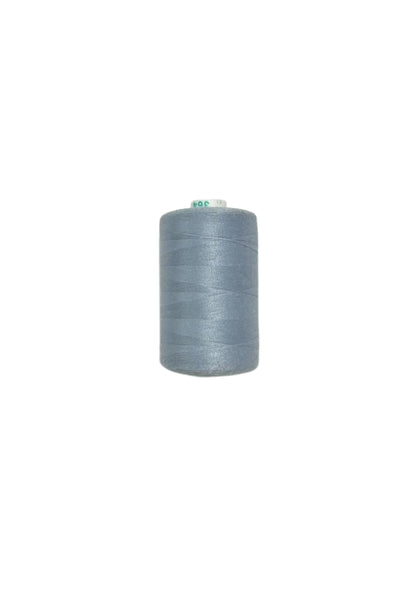 A close-up of a spool of Super Cheap Fabrics' pale blue spun polyester thread against a plain, white background. The 1000 Mtrs thread is tightly wound around the cylindrical spool, with a small green and white label affixed to the top.