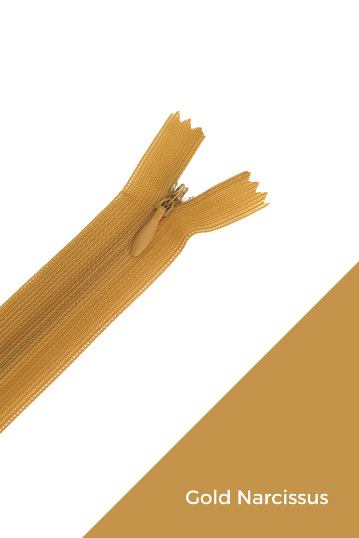 A gold-colored, durable zipper from Super Cheap Fabrics is partially unzipped against a white background. The bottom right corner of the image features a gold diagonal stripe with an elegant finish and the text "Invisible Zip - 30cm - Yellows & Oranges" written in white.