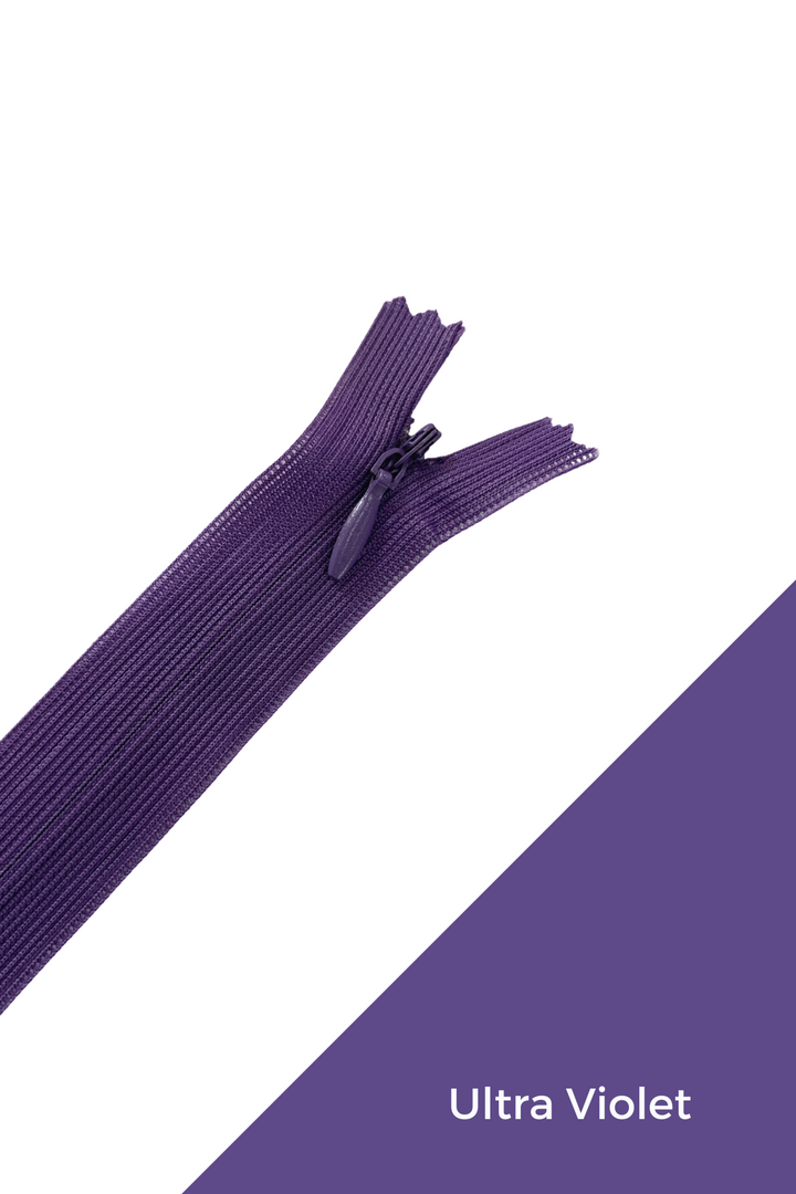 A partially unzipped, durable zipper from the Super Cheap Fabrics Invisible Zip - 30cm - Purples line lies diagonally across a white and violet background. The text "Ultra Violet" is written in the lower right corner of the violet section.